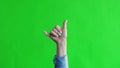 Hand shows Shaka sign on green screen background Hawaiian gesture relax Royalty Free Stock Photo