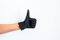Hand shows thumb up in rubber glove. on a white background
