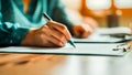 Hand signing a document on a desk. Royalty Free Stock Photo