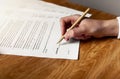 Hand signing legal business agreement with pen. Contract signature by women closeup Royalty Free Stock Photo