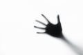 Hand silhouette behind a glass Royalty Free Stock Photo