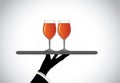 Hand silhouette presenting two stylish glasses with red wine