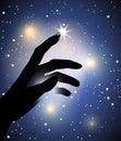 Hand silhouette touching with a finger a star