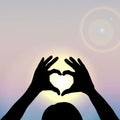 Hand Silhouettes forming a heart with sun inside. Vector