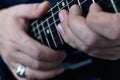 Hand with silver ring on his finger playing on semi-acoustic guitar Royalty Free Stock Photo