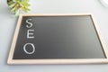 Hand-sketched SEO concept in white chalk on a black Board
