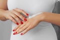 Hand Skin Care. Close Up Of Female Hands Applying Cream, Lotion. Beautiful Woman Hands With Red Manicure. Nails Applying Cosmetic Royalty Free Stock Photo