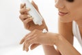 Hand Skin Care. Closeup Of Beautiful Woman Applying Cream Royalty Free Stock Photo