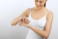 Hand Skin Care. Women use body lotion on your arms. Female applying cream to her hands