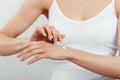 Closeup shot of woman hands holding cream and applying moisturizing hand cream. Beautiful female hands with cream. Royalty Free Stock Photo