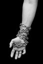 Hand of slave with chains. Hand tied chain