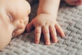 Hand of sleeping baby close up on the bed