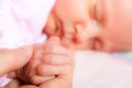 Hand the sleeping baby girl in the palm of mother Royalty Free Stock Photo