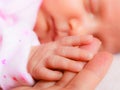Hand the sleeping baby girl in the palm of mother Royalty Free Stock Photo