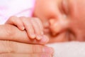 Hand the sleeping baby girl in the palm of mother Royalty Free Stock Photo