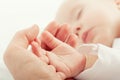 Hand the sleeping baby in the hand of mother Royalty Free Stock Photo