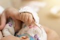 Hand of sleeping baby in the hand of mother while breastfeeding. Royalty Free Stock Photo