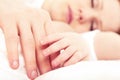 Hand the sleeping baby in the hand of mother Royalty Free Stock Photo