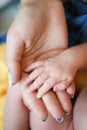 Hand the sleeping baby in the hand of mother close-up. Royalty Free Stock Photo