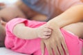 Hand of sleeping baby in the hand of mother close up on the bed. Mother with her baby sleeping on bed at home Royalty Free Stock Photo