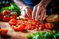 hand slicing fresh tomatoes for bruschetta