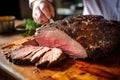 hand slicing a piece of stout-glazed beef brisket