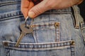 hand sliding hotel key into the back pocket of jeans Royalty Free Stock Photo