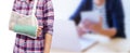 hand in a sling with broken arm in green cast isolated on blurred background working woman with office desk workplace in office