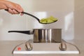 A hand with a slotted spoon takes dumplings out of the pot.