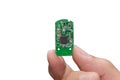 Hand with small electronic microchip microcontroller isolated