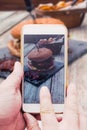 Hand with smart phone, taking picture of burger food