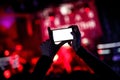 Hand with a smartphone records live music festival, live concert, show on stage Royalty Free Stock Photo