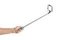 Hand and smartphone with selfie stick Royalty Free Stock Photo