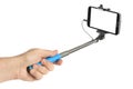Hand and smartphone with selfie stick Royalty Free Stock Photo