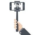 Hand with smartphone on selfie stick Royalty Free Stock Photo