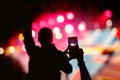 Hand with a smartphone shooting live music festival, concert Royalty Free Stock Photo