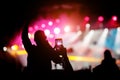 Hand with a smartphone shooting live music festival, concert Royalty Free Stock Photo