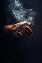 Hand in smoke on black background. Royalty Free Stock Photo