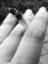 Hand smoking closeup black&white fingers