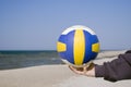 Hand with soccer ball on beach Royalty Free Stock Photo