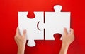 Hand solving a puzzle piece on red background Royalty Free Stock Photo