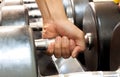 Hand someone holding dumbbell in gym.