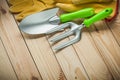 Hand spade and fork with gloves on wood. garden tools Royalty Free Stock Photo