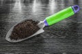 Hand spade soil on wooden board gardening concept