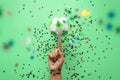 Hand spinning paper soccer ball on green background. Origami. Paper craft. Soccer game concept Royalty Free Stock Photo