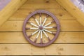 A hand-spinning wheel on the wall, half the roof Royalty Free Stock Photo