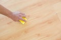 Hand with sponge cleaning the parquet floor at home Royalty Free Stock Photo