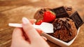 Hand with a spoon. Homemade chocolate ice cream with chocolate and strawberries Royalty Free Stock Photo
