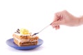 Hand with spoon snap off a peace of cake Royalty Free Stock Photo