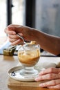 Hand with spoon taking Affogato coffee